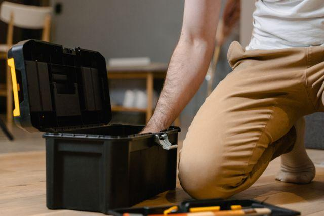 A person reaching into a toolbox
